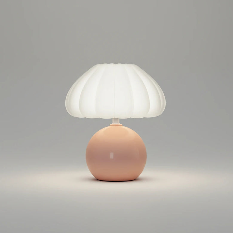 Hero Table lamp with a white shade and pink base on a grey background.