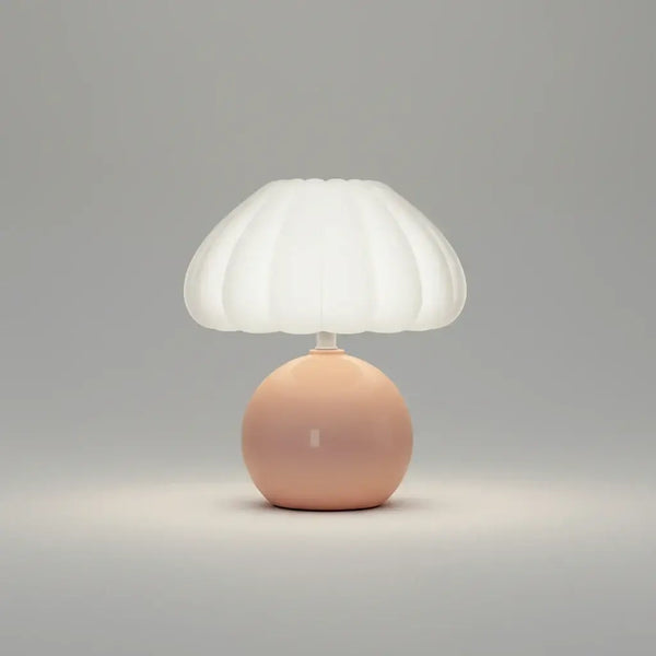 Hero Table lamp with a white shade and pink base on a grey background.