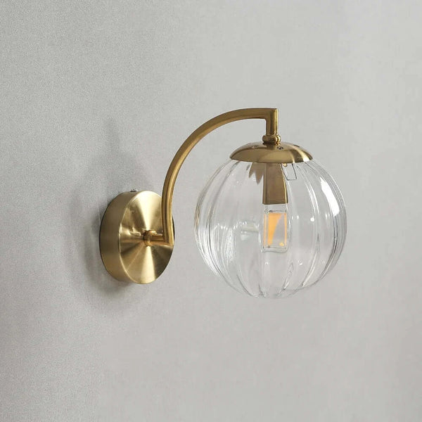 Colourful Glass Modern Wall Light with a golden metal base and transparent colorful bulb, enhancing indoor decor.