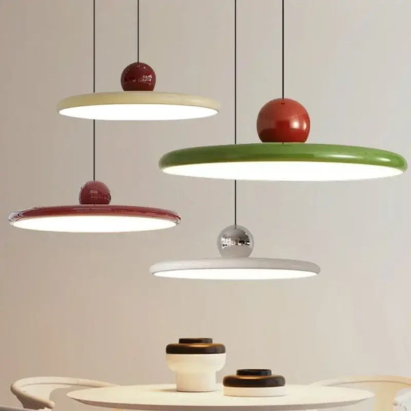 Modern Minimalist Pendant Lamp – Elegant Bedside & Dining Room Lighting in cream, red, and green hanging above a table.