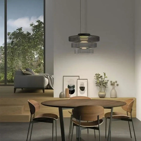 Layered Glass Pendant Light – Modern Amber, Green or Smoke Grey LED Suspension illuminating a stylish dining area.