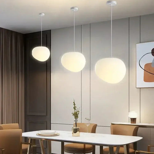 Simple Nordic Restaurant Pebble Chandelier hanging above a dining table in a modern interior space.