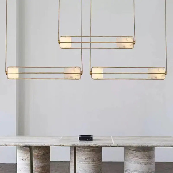 Elegant White Glass & Metal Art Deco Chandelier hanging above a stylish table in a modern setting.