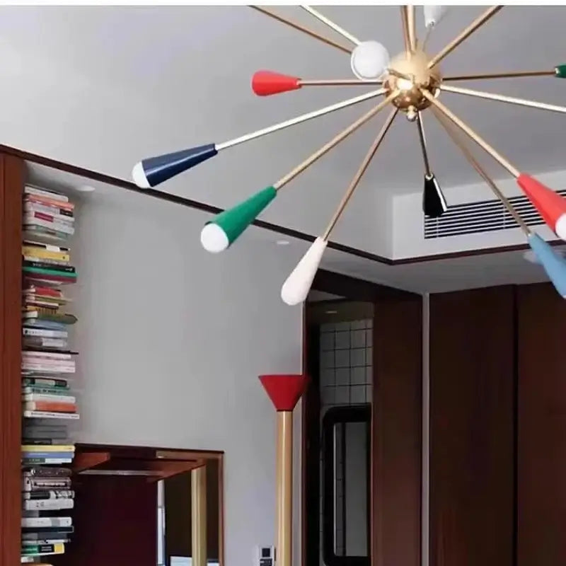 The Ultimate MCM Statement Light – Atomic Sputnik Chandelier in a stylish room with bookshelves, displaying its multicolour design.