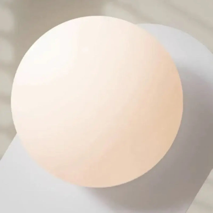 Discover the Vintage Elegance of the 70s-Inspired Metal and Glass Sconce featuring a frosted glass globe.