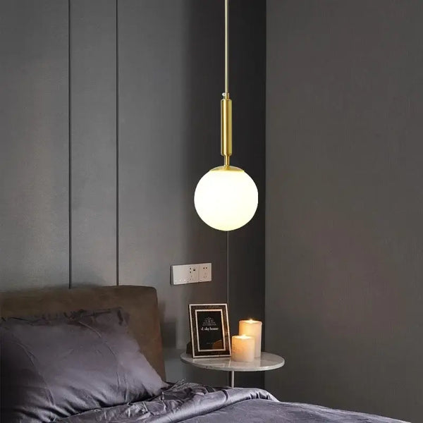 Mid-Century Modern Glass Ball Pendant Light hanging in a stylish bedroom setting with soft lighting.