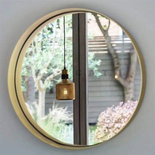 Elegant Radiance: The Gold LED Wall Lamp – Where Style Meets Function reflected in a round mirror.