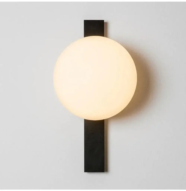 Decorative Lighting Fixture With Milk White Glass Sphere mounted on a wall, featuring a sleek black finish.