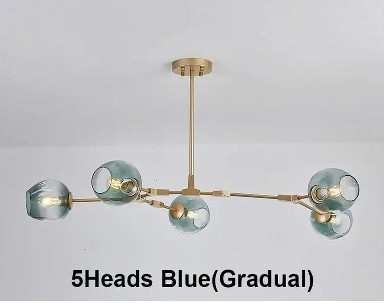 A modern 5-head chandelier with a brushed gold/brass metal frame and gradient blue-tinted glass shades, shown hanging against a plain white ceiling. Text at the bottom reads '5Heads Blue(Gradual)'.