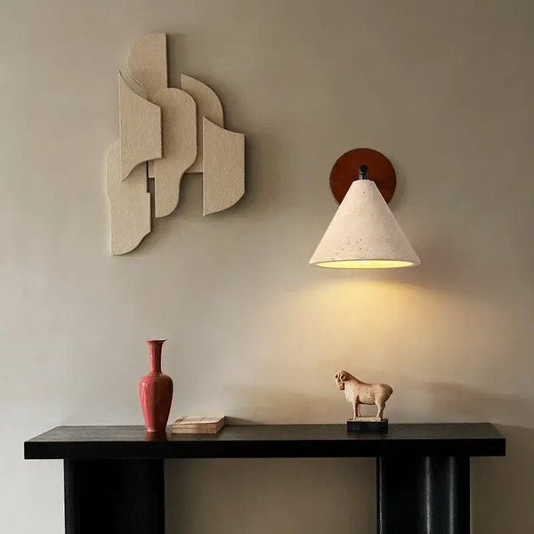 Natural Travertine Stone Wall Lamp – Modern LED Sconce for Bedrooms illuminating a stylish living space with art.