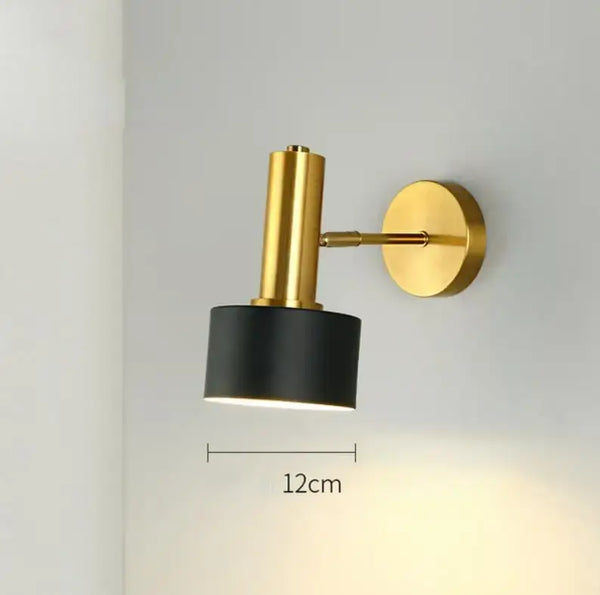 Gold Wall Mounted Spot in Brass and Black Colours featuring a sleek design on a wall.
