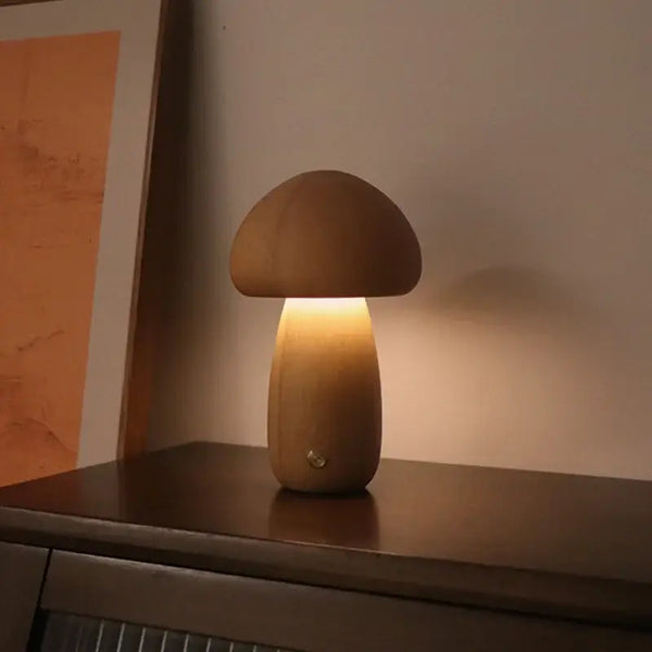 Portable Dimmable 60s Italy Designer Mushroom Table Lamp on a wooden surface, emitting a warm glow in a cozy setting.