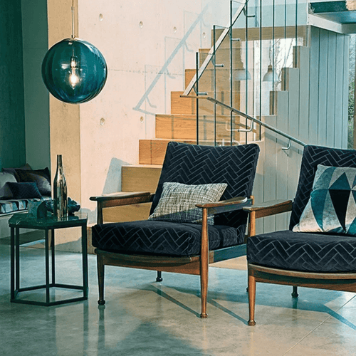 Delicious Lollipop Modern Pendant Light illuminating a stylish parlor with comfortable chairs and a modern design.