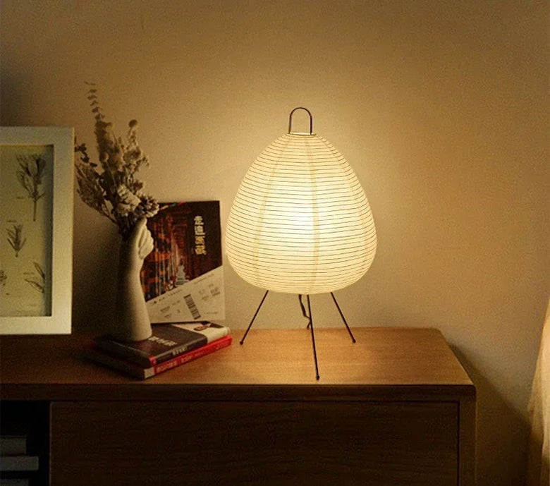 Japanese Ride Paper table Lamp. Woven table lamp on a wooden surface with a warm glow