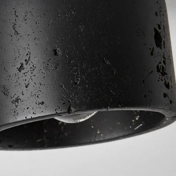 Close-up of the Black Travertine Ceiling Lamp showcasing its textured surface and modern design.
