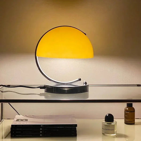 80s USB desk lamp in various colours illuminating a stylish desk with decorative items.