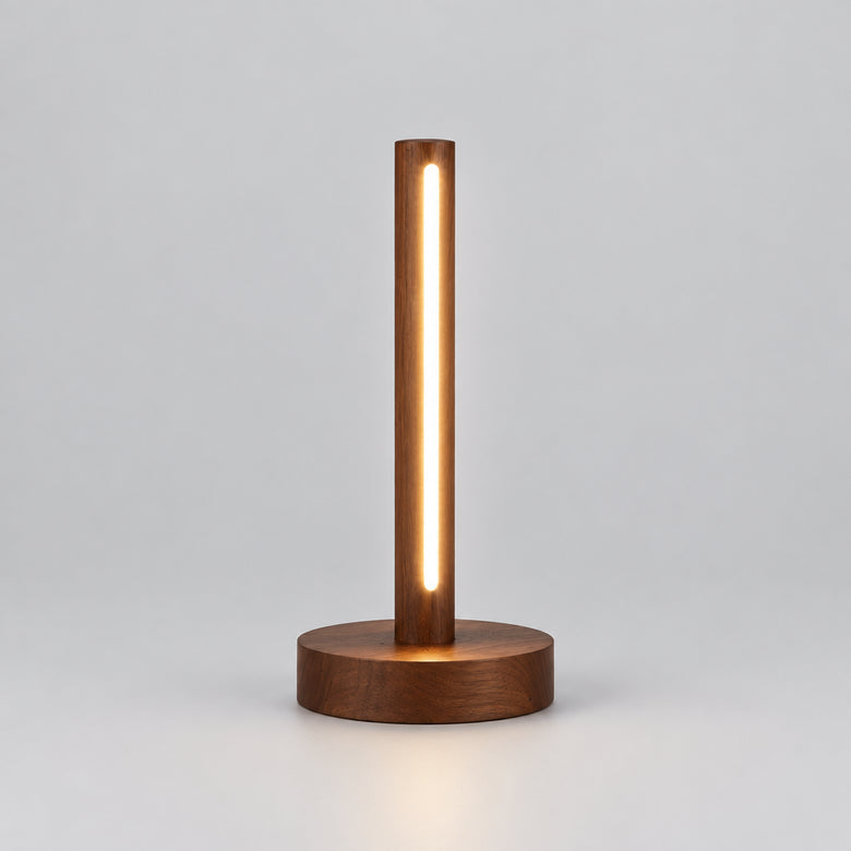 A modern cylindrical LED desk lamp with a warm glowing vertical light bar and a round wooden base,