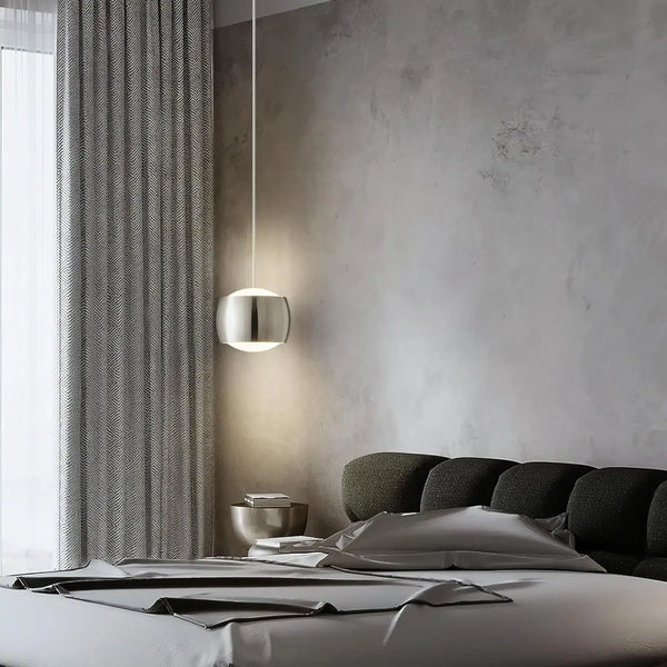 French Nouvelle Vague Pendant Light illuminating a modern bedroom with minimalist decor and soft textures.