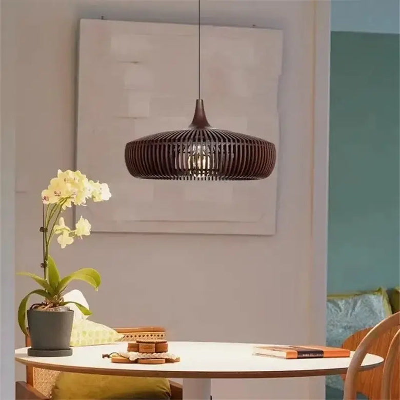 Vintage Wooden Pendant Light – Handcrafted Nordic Birdcage Lamp hanging above a dining table with an orchid plant.