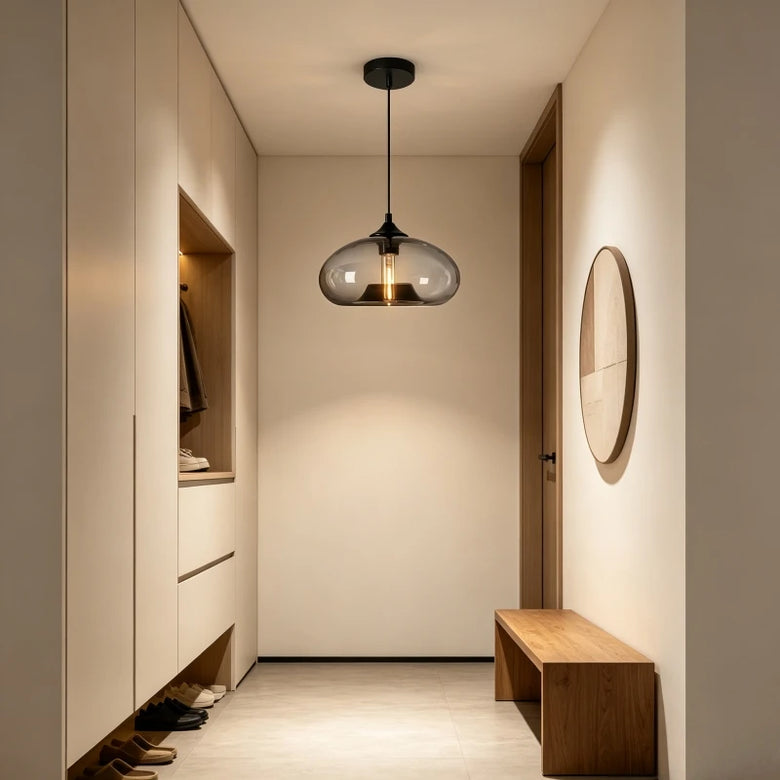 Smoke grey glass dome pendant light in a hallway with a bench