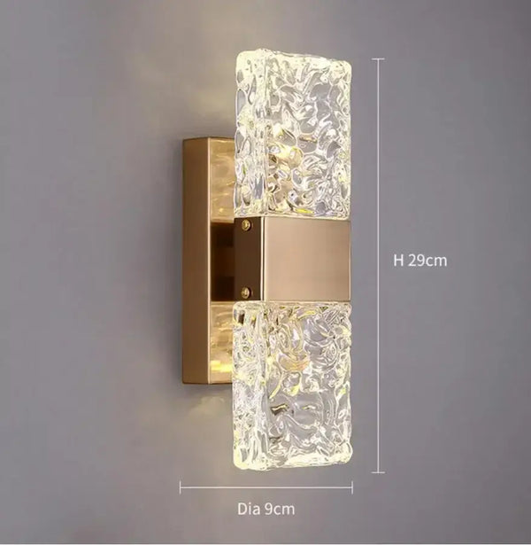 Unique Collection of Art Deco Sconces with elegant design and glowing crystal accents in gold finish.