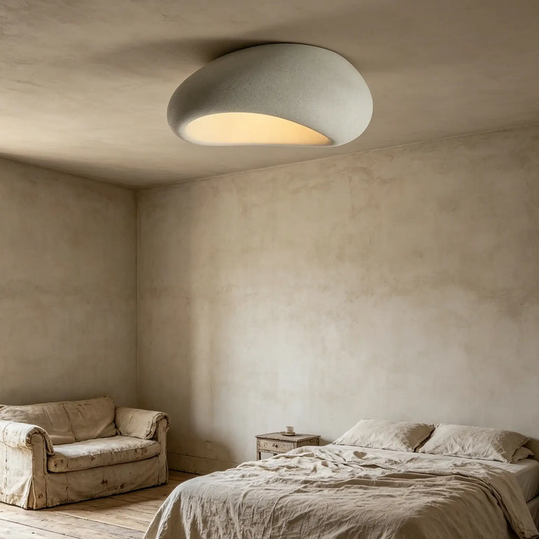 Organic stone ceiling light grey white illuminating a modern bedroom with soft, sculptural design.