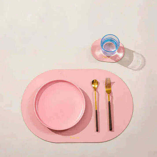 Modern dining setup with pink placemat and table setting, exploring 'Placemats or tablecloths?' article focus keyword.