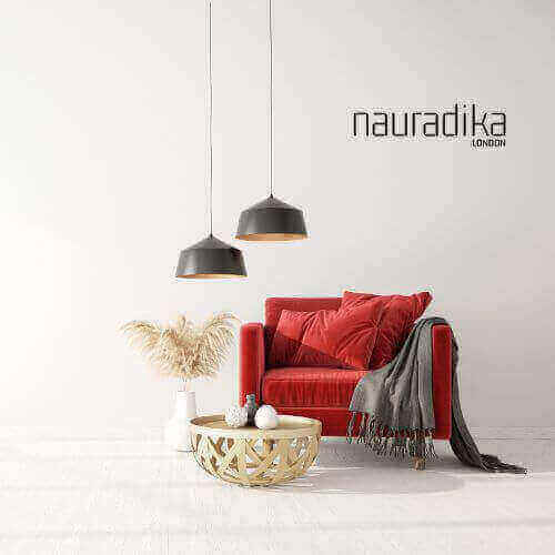 Red sofa with decor accents in modern living room, highlighting use of red in interior design, featuring pendant lights and woven table.