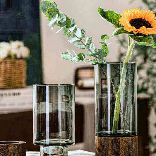 Nordic Glass Vases by Nauradika, featuring elegant design with a wooden base, perfect for enhancing home decor with a sunflower arrangement.