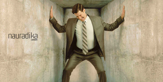 Man in business suit in narrow space, illustrating the challenge of Lighting for Small Spaces.