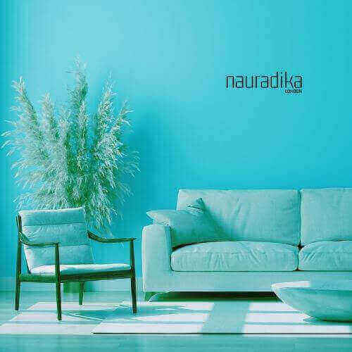 Cozy living room with petroleum blue sofa and chair, enhancing the interior design.