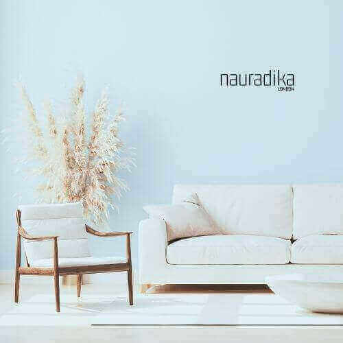 Modern living room showcasing use of baby powder blue in interior design, featuring a white sofa and minimalist decor.
