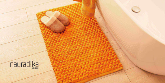 Guide to picking the perfect bathmat – luxury yellow bathmat with slippers by Nauradika, enhancing bathroom style and safety.