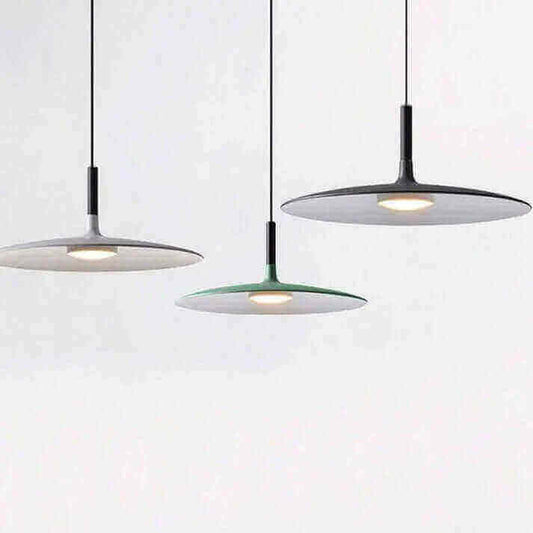 The Sleek, Modern LED Pendant Lamps hanging in a minimalist arrangement, enhancing room ambiance with Foscarini Aplomb design.