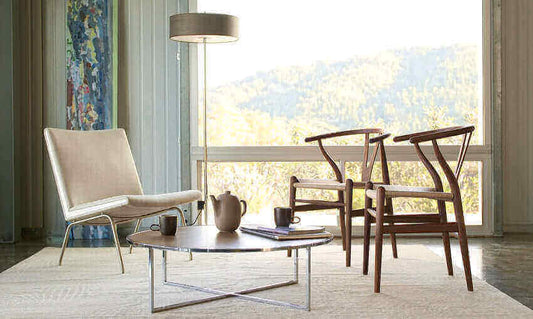 Modern living room showcasing Hans Wegner and interior design with classic chairs and table.