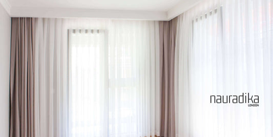 Hanging curtains wider than the window makes the room feel larger