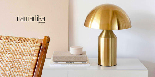 Modern interior decor featuring a golden lamp and books on a minimalist white table - Don't overcrowd your interior