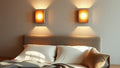 Cozy bedroom with travertine wall lamps: bring natural stone warmth to your home this autumn highlighting the 2026 lighting trend.