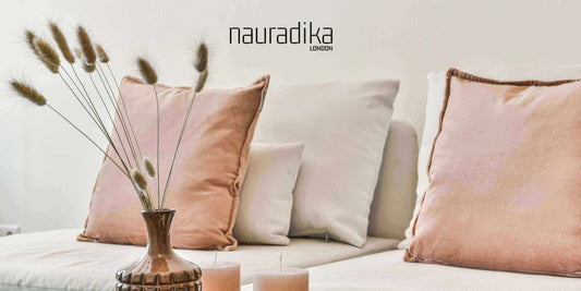 Layer textures: Adding layers of textures creates depth and dimension to a space with soft pillows and natural elements on a couch.