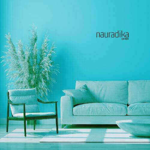 Modern living room featuring a petrol blue sofa and chair, showcasing the Use of Petroleum Blue in Interior Design with stylish decor.