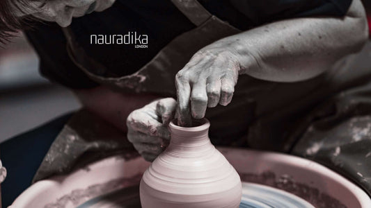 Artist shaping a vase on a pottery wheel, highlighting traditional crafting techniques. A brief history of vases.