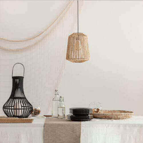 Dining table setup showcasing the use of beige in interior design with beige runner and woven decor.