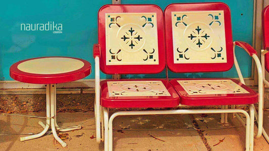 Vintage metal patio furniture exemplifying key design styles of the 20th century with red and white geometric patterns.
