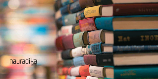 Stack of colorful books for a relaxing living room aesthetic. What are the key decorative accessories to make a living room feel more relaxing.
