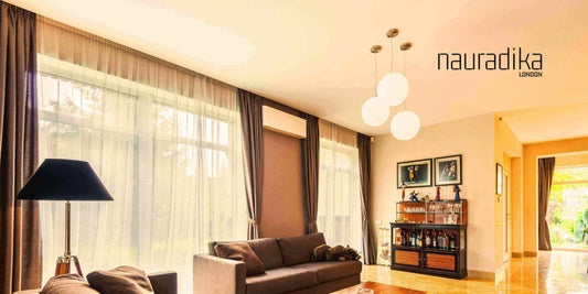 Modern living room demonstrating how to hang curtains higher in interior design for a luxurious and spacious look.