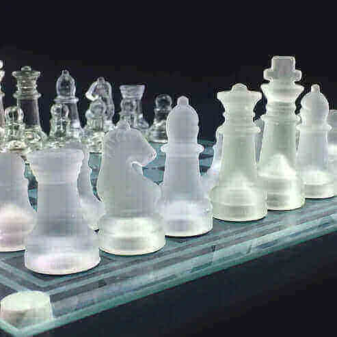 Glass Chess Set vs traditional chess sets on a reflective board