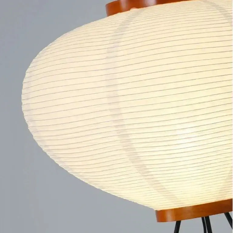 Close-up of a Japanese Rice Paper Lamp with a wooden base and white paper shade on a gray background