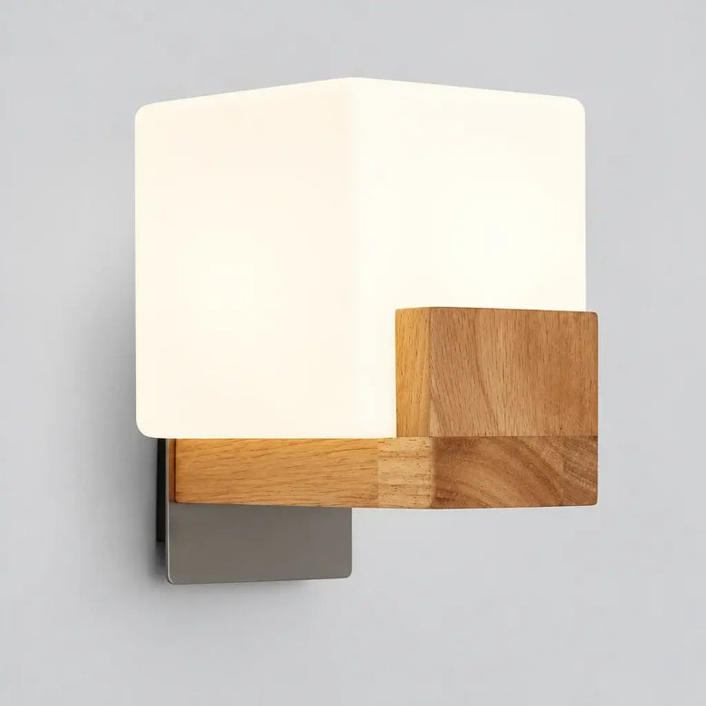 Hero A wall-mounted square sconce shown in a split comparison: left side labeled 'Light ON' with the lamp glowing warm white. The fixture has a white square shade, natural wood side panel, and brushed metal base against a light wall.