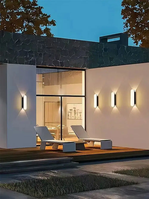 Aluminum Outdoor Modern Nordic Dimmable Wall Lamp illuminating a stylish patio area at dusk.