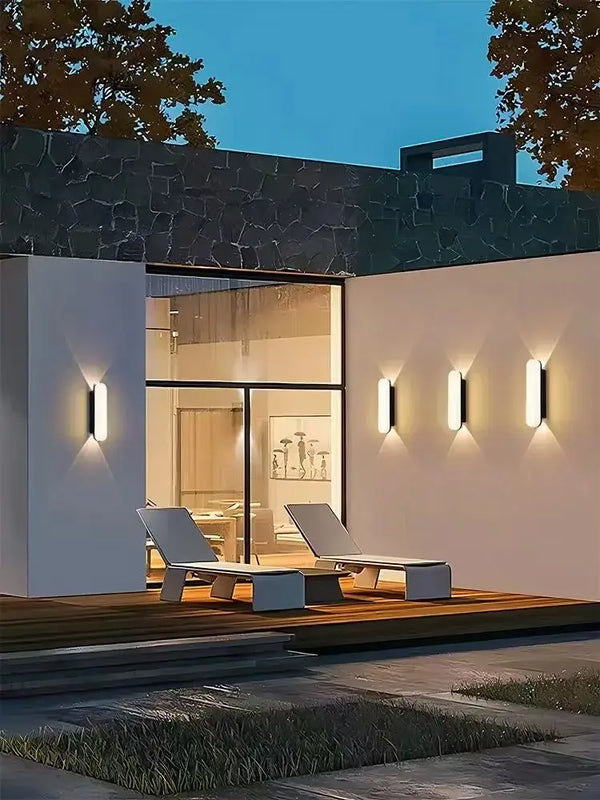 Aluminum Outdoor Modern Nordic Dimmable Wall Lamp illuminating a stylish patio area at dusk.